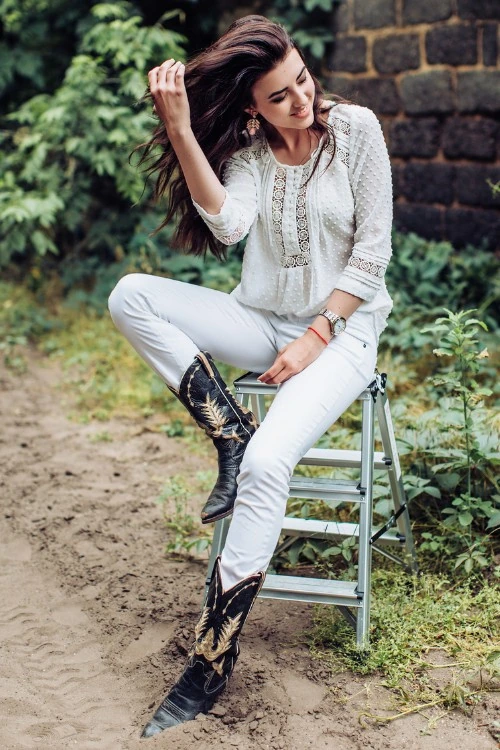 Black Cowboy Boots With White Jeans And Boho Top