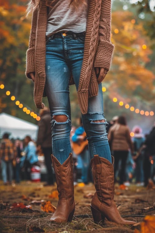 Ripped Jeans Tucked Into Brown Cowboy Boots With A Warm Cardigan